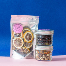 Load image into Gallery viewer, A set of two jars with botanicals infusion and a pack of dehydrated lemon &amp; lime.
