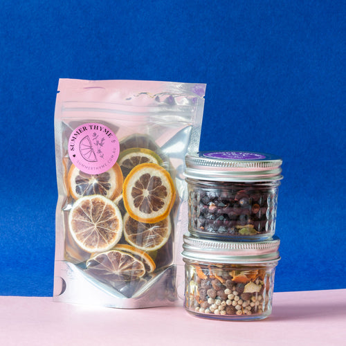 A set of two jars with botanicals infusion and a pack of dehydrated lemon & lime.