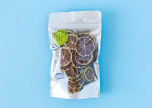 Load image into Gallery viewer, Large Summer Thyme Co. pack of dehydrated lime citrus garnish on a light blue background.
